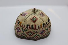 •Diameter: 4.5",  Height: 3"•1930-1960’s handmade embroidered hat from Uzbekistan, Turkmenistan•Made of organic cotton, wool, goat hair, colors are a combination of synthetic and natural dyes•Dry clean only•Stand not included•LoomLoreGallery ID: CAC 13.2 Traditional Handmade Green Hats, Vintage Costume Cap For Festival, Traditional Embroidered Flat Cap, Traditional Handmade Cap Hat, Vintage Multicolor Flat Cap, Vintage Embroidered Hat With Curved Brim, Vintage Handmade Cap Hat, Handmade Vintage Cap Style Hat, Handmade Vintage Cap Hats