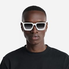 a man wearing white sunglasses and a black t - shirt