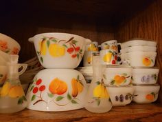 a shelf filled with lots of dishes and cups