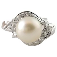 Vintage 14K White Gold Diamond and Pearl Ring Size 5.25 This beautiful 14K white gold ring features a gorgeous white pearl and 10 old single cut diamonds for a stunning look! Pearl: 7.84mm Approximate total diamond weight: .10 cts Diamond color: I Diamond clarity: VS Ring size: 5.25 Shank: 1.6mm Weight: 1.9 dwt/ 3.0 g Hallmark: 14K Very good condition, professionally polished. Will come packaged in a gift box or pouch (when possible) and will be shipped U.S. Priority Mail Insured. MM010824/17KCS Diamond And Pearl Ring, Pearl And Diamond Ring, 14k White Gold Ring, White Gold Ring, Jewelry Vintage, Jewelry Rings Engagement, Ring Jewelry, Pearl Ring, White Pearl