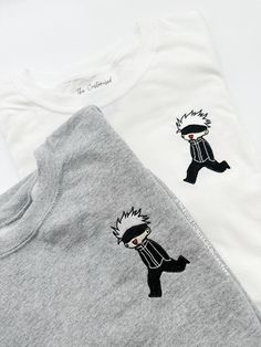 Elevate your anime wardrobe with this stunning Embroidered Sukuna JJK Shirt--the perfect choice for anime enthusiasts!  The detailed embroidery ensures the design won't fade or peel over time, and the unisex fit caters to all fans.  Available in a variety of sizes, this shirt is a must-have for those who want to stand out and rep their favorite anime villain. White Cotton Hoodie With Anime Print, Cotton Character Print Sweatshirt For Cosplay, White Cotton Sweatshirt With Anime Print, Anime Cotton Sweatshirt With Crew Neck, Anime Cotton Sweatshirt For Fan Merchandise, Anime Cotton Sweatshirt For Fans, Embroidered T-shirt For Winter Streetwear, White Cotton Cosplay Sweatshirt, White Cotton Sweatshirt For Cosplay