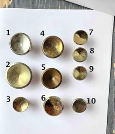 an assortment of metal knobs on top of a piece of paper