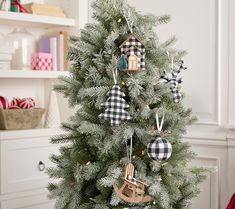 a small christmas tree with ornaments hanging from it