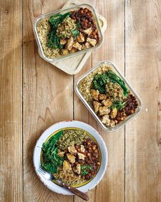 three containers filled with food sitting on top of a wooden table