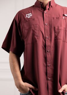 This short sleeve button down Columbia Tamiami is essential for the outdoorsy Aggie! Columbia's lightest-weight fishing shirt, it features a small, embroidered white ATM logo on the right chest. With Omni-Shade Sun Protection (UPF 40), this shirt will keep you cool and comfortable all day long. - Brand: Columbia - Shell & Mesh Lining: 100% Polyester - Machine Wash Cold / Gentle Cycle - Tumble Dry Low / Do Not Dry Clean Deep Maroon, Texas A&m, Maroon Color, Fishing Shirts, Keep Your Cool, Sun Protection, Columbia, Fishing, Texas