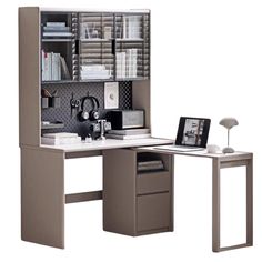 an office desk with a bookcase and computer on it