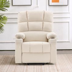 a white recliner chair sitting on top of a rug in front of a wall