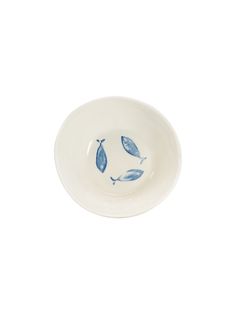 a white bowl with blue fish on it's side and the bottom is empty