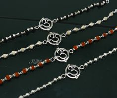 This amazing silver Rakhi crafted from 925 silver with immense precision. It exudes excellent craftsmanship and will surely look wonderful on your brother's wrist. handmade custom design Aum or OM Bracelet Or Rakhi bracelet with silver, rudraksha and holy Basil Rosary beaded chain, this is special design beaded bracelet we can use either Rakhi bracelet or daily use bracelet for unisex. Best Rakshabandhan Festival best wishes sibling gift for your brother and sister's , buyer can be select bracel Silver Bracelet For Puja And Festivals, Symbolic Sterling Silver Bracelets For Festivals, Sterling Silver Bracelets For Festivals, Adjustable Sterling Silver Spiritual Bracelet For Festivals, Adjustable Spiritual Sterling Silver Bracelet For Festivals, Traditional White Sterling Silver Bracelets, Sterling Silver Beads Jewelry For Puja, Sterling Silver Beaded Jewelry For Puja, Sterling Silver Jewelry With Silver Beads For Puja