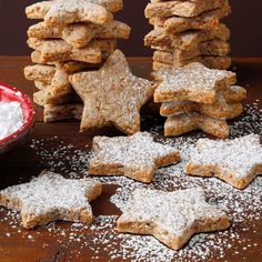 a pile of cookies with powdered sugar on top