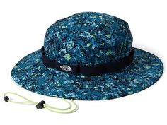 The North Face Class V Brimmer - Caps : Beta Blue Lichen Print : Ensure 360-degree sun protection to your kid's face with The North Face Class V Brimmer, featuring a cinchable cord for wet, warm, and all kinds of days. Ultraviolet Protection Factor (UPF) 40+. Wide, floatable brim for maximum sun protection. FlashDry sweatband keeps you cool and dry. Embroidered logo on external band. Chin strap with cord lock. 94% nylon, 6% elastane. Hand wash, line dry. Imported. Measurements: Circumference: 23 Casual The North Face Hats For Hiking, Casual The North Face Hats For Travel, Casual The North Face Bucket Hat, The North Face Summer Hats For Outdoor Activities, The North Face Bucket Hat For Outdoor, Functional The North Face Hat For Outdoor Activities, Adjustable Multicolor Sun Hat For Outdoor Activities, Blue Adjustable Sun Hat For Outdoor Activities, Adjustable Blue Sun Hat For Outdoor Activities