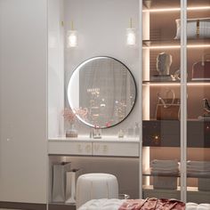 a white dressing table and mirror in a room with lights on the wall behind it