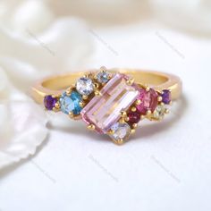 Emerald Cut Pink Sapphire Cluster Ring Multi Gemstone Engagement Ring 18K Yellow Gold Jewelry Art Deco Bridal Ring Anniversary Gift For Wife Description: Main Stone - Sapphire Stone Size - 7 x 5 MM Stone color - Pink Main Stone creation - Lab Created Stone shape - Emerald  Birthstone - September Secondary Stone - Multi Gemstone (Ruby, Aquamarine, Topaz, Amethyst) Stone Color - Multi Color Stone Shape - Round Finishing- Excellent feel free to contact me if you have any questions  Gemstone color may slightly vary from listed image due to the nature of all natural gemstone or different monitor settings TURNAROUND TIME Your order will be ready for shipment in 4-8 business days. Free economy shipping for US, UK, Germany- 10-15 business days delivery time. shipping upgrade available for US, UK, Elegant Yellow Gold Multi-stone Crystal Ring, Elegant Multicolor Amethyst Ring For Anniversary, Pink Multi-stone Cluster Ring As A Gift, Gold Birthstone Ring With Cubic Zirconia, Elegant Multicolor Cluster Ring As Gift, Elegant Multicolor Cluster Ring For Gift, Gold Sapphire Ring With Multi-stone Cubic Zirconia, Rose Gold Multi-stone Cubic Zirconia Ring, Pink Multi-stone Rings For Anniversary