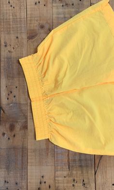 "High waisted 90's windbreaker shorts. High waist and looser through hips and thighs. Full elastic waistband. These shorts are bright neon yellow which is a hard color to pick up in photos. Shorts are in excellent clean condition. Measurements (taken zipped or buttoned up and laid comfortably flat) inches Tag Size Small Waist 24\"~27\"(stretch) Hips 40\"(loose) Length 15.5\" Inseam 4\" Rise 13.5\" Top thigh circumference 27\" All items are free of rips, tears, holes, and stains unless otherwise Windbreaker Shorts, Levis Jeans High Waisted, Levi High Waisted Shorts, Levis Mom Jeans, Stretch Hips, High Waisted Jeans Vintage, 90s Windbreaker, Nylon Shorts, 90s Shorts