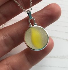 Sea glass marble! Yellow cat's eye beach marble with bright yellow streak. This is a minimalist necklace, with lovely tumble marks from the strong currents of the North Sea on the English East Coast.  Sea glass marble is set in silver plated bezel setting on silver plated chain in length of your choice. The marble has not been channel drilled, it is set in the silver wrapping without having been altered.  SIZE Marble is approx 16mm diameter Comes with a silver plated chain in length of your choi Marble Necklace, Beach Necklace, Beach Necklaces, Yellow Cat, Glass Marbles, North Sea, Beach Glass, Minimalist Necklace, Bezel Setting