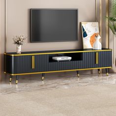 an entertainment center with a flat screen tv mounted on it's side, in front of a beige wall