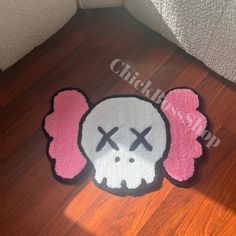 a pink and white rug with a skull on it