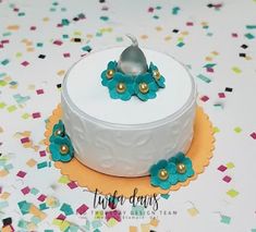 a white cake with blue flowers on top