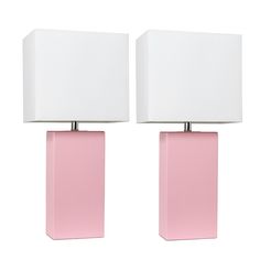 two pink lamps with white shades on them