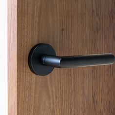 an open door handle on a wooden door