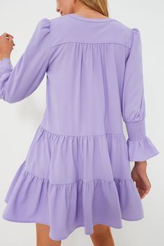 A Tuckernuck fan favorite, the Lilac Kenzo Dress is the mini of the season. Featuring feminine flutter smocked cuffs, a V-neckline and a loose empire waist, this is the most flattering flirty frock! Pair with flats for a casual look or dress it up with heels and statement earrings for date night. V-neckline Long sleeves Elasticated ruffle cuff Swing shape Tiered skirt Mini length Material: 95% Polyester, 5% Spandex Care: Hand wash cold Kenzo Dress, Skirt Mini, Lilac Dress, Tier Skirt, Tiered Skirt, Empire Waist, Get The Look, Statement Earrings, Smocking