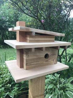 a bird house built on top of a wooden post