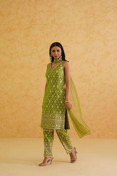 Green Brocade Kurti Pant Set | Deepika Chadha Deepika Chadha's stunning green Brocade fabric kurti, beautifully adorned with intricate crystal, stone and sequins embroidery. The stylish brocade pants adds a touch of glamour and sophistication to your look, while the net Dupatta ensures you feel comfortable all day or night long. Included in Purchase: Kurti, Pants & Dupatta Set Product Specification Color: Green Fabric: Brocade, Net Neckline: V-neck Occasion: Bridal, Engagement, Formal Event Designer: Deepika Chadha Work: Hand Embroidery Gold Beads Sequins, Stones, Cutdana, Crystals Care Instructions: Dry Cleaning only, No Flat Ironing on Hand Embroidery *Jewelry sold separatelyCustomization options:Can be customized in any color or blouse style Note: A stylist will contact you to confirm m Green Bollywood Pant Set With Resham Embroidery, Green Resham Embroidered Pant Set For Wedding, Green Resham Embroidery Pant Set For Wedding, Green Pant Set With Resham Embroidery For Wedding, Festive Green Pant Set With Resham Embroidery, Green Fitted Designer Pant Set, Festive Green Pant Set For Wedding, Green Fitted Pant Set For Wedding, Fitted Green Pant Set For Wedding