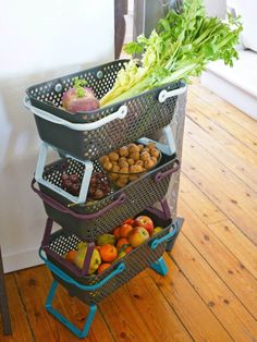 three baskets stacked on top of each other with fruits and vegetables in the bottom basket