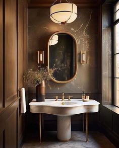 a bathroom with a sink, mirror and vase on the counter in front of it