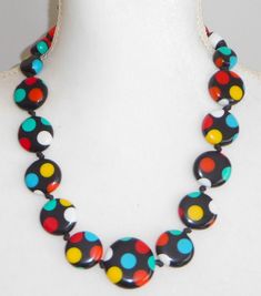 This necklace is part of the Dots line and is called by the same name. What a fun and bright collection!  This line features a combination of classic and timeless polka dots with the modern and stylish design of Sobral pieces. With three color options these pieces allow you to be creative and put together several incredible combinations. They look beautiful as a single piece or mix and match sizes and colors. Get your DOTS pieces now and splash style wherever you go with this amazing new collection. This necklace features 19 graduated beads with a multicolor polka dot motif on a jet black background. The beads are individually hand knotted and the length is adjustable up to 29". I also have the matching bracelet, ring and earrings available plus I have this in additional colors. The first Artisan Jewelry Necklaces, Bracelet Ring, Handcrafted Artisan Jewelry, Earring Cards, Matching Bracelet, Fabric Jewelry, Be Creative, Matching Bracelets, Three Color