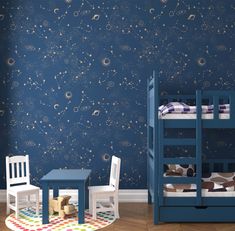 two children's bunk beds in front of a wall with stars and planets on it