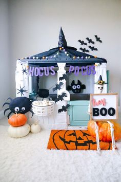 a halloween themed party with decorations and pumpkins on the floor in front of a tent