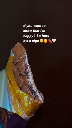 a piece of cake sitting on top of a wrapper with the words if you want to know that i'm happy? so here it's a sign