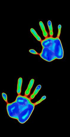 two blue and green hand prints on a black background, with one being colored red