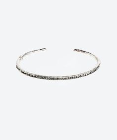 Sophisticated and brilliant crystal tennis bangle, feature a dainty, feminine and unique design. Wear it every day or for a glamorous occasion! Weight: 9 grams Size: 5.7"" circumference Wristband: Includes a hidden hinge for easy slide on and off Materials: SwarovskiTM crystals Precious base Metal: .925 Sterling Silver Texture: Hand hammered Sterling Finish: Gold: 24K Gold dipped Dark: Oxidized and/or Black Rhodium dipped Luxury Adjustable Tennis Bracelet Bangle, Elegant Crystal Bangle Tennis Bracelet, Luxury Hand-set Tennis Bangle Bracelet, Luxury Gemstone Tennis Bangle, Adjustable Tarnish-resistant Diamond Bangle Bracelet, Silver Texture, Gallery Jewelry, Rose Gold Bangle, Slide On