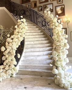 a bunch of flowers that are on the stairs