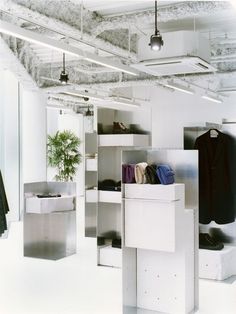 an open closet with clothes and other items on shelves in the center, along with hanging lights