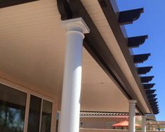 an outside view of a house with white pillars