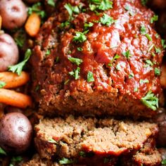 sliced meatloaf with carrots, potatoes and parsley on the side for garnish