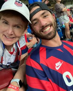 a man and woman sitting next to each other at a soccer game