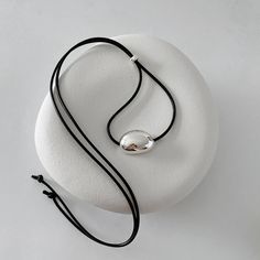 🫘Minimalist Black Cord Necklace with Silver Bean Pendant 🫘 Made with a black leather-like string cord and featuring a bold chunky bean pendant in sterling silver. The self-adjustable length allows for personalized comfort and style. The minimalist design and simple, clean lines make it a versatile accessory that complements any outfit, making it an ideal choice for summer wear. **This Made-to-Order necklace may take up to 2-3 weeks to dispatch if silver components are temporarily unavailable. Modern Silver Necklace With Adjustable Cord, Modern Black Jewelry With Sliding Knot, Minimalist Pendant Necklace With Adjustable Cord, Minimalist Choker Necklace With Sliding Knot, Silver Necklaces With Adjustable Cord For Everyday, Silver Necklace With Adjustable Cord For Everyday, Black Sterling Silver Necklace With Adjustable Cord, Ear Cuff Piercing, Cord Choker