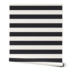 a black and white striped wallpaper with horizontal stripes on the bottom half of it