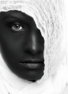 a black and white photo of a woman's face with a bandage on her head