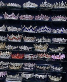 many tiaras and crowns are displayed on shelves