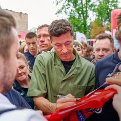 a man is signing autographs for people