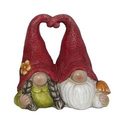 two gnome figurines sitting next to each other