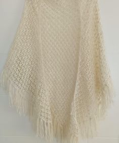 This Long tassel shawl is 100% handmade. This beautiful triangular scarf in cream color is perfect as an accessory for cool evenings or simply to ward off the spring or autumn cold. It is a great gift for mothers. The boho scarf measures 80" from wing tip to wing tip and 43" from center top to tip - when worn over your shoulders, it hangs under your hips and fits neatly around you! Knitted from 30% cotton, 20% wool, 50% acrylic sports weight yarn, it is shiny, light enough for summer and warm en Wedding Crochet, Wedding Shawls, Shawl Wedding, Boho Scarf, White Shawl, Boho Scarfs, Sport Weight Yarn, Crochet Wrap, Wedding Shawl