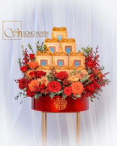 a red and gold cake with flowers in it