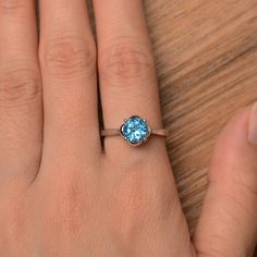 It is a real Swiss blue topaz ring, round cut, measures 7mm*7mm, weight about 1.68 cts. The basic metal is sterling silver and plated with rhodium. To change the metal to a solid gold (white/rose) or platinum is also available, please ask for a quotation if you want. You can also go to my shop Home for more elegant rings: https://www.etsy.com/shop/godjewelry?ref=hdr_shop_menu Swiss blue topaz is birthstone of November More Swiss blue topaz rings: https://www.etsy.com/shop/godjewelry?ref=seller-p Classic Topaz Ring With Round Cut, Classic Round Cut Topaz Ring, Classic Sterling Silver Solitaire Topaz Ring, Classic Round Topaz Birthstone Ring, Blue Topaz Solitaire Crystal Ring, Topaz Birthstone Ring For Promise With Round Cut, Elegant Topaz Birthstone Ring For Promise, Promise Topaz Birthstone Ring, Classic Sterling Silver Topaz Ring With Round Stone