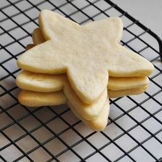 some cookies are on a cooling rack and one is shaped like a star or snowflake